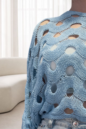 Renueva tu fondo de armario con nuestro suéter de punto calado. Confeccionado en 100% algodón, ofrece un diseño artesanal y ligero en tonos azul, beige y blanco perlado.