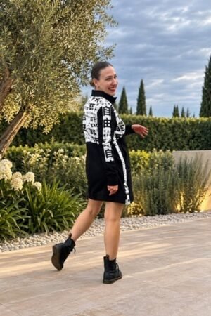 Mujer con vestido sudadera negro y blanco de OH.LA y botas de cordones